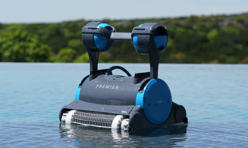 Dolphin Premier robotic pool cleaner at the waterline of an infinity pool